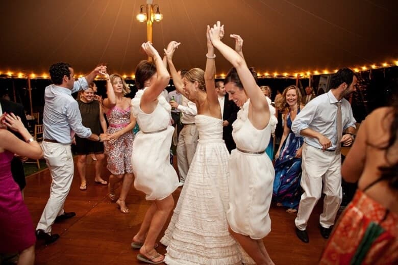 Wedding guests dancing together at a reception